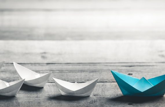 Blue,Paper,Boat,Leading,A,Fleet,Of,Small,White,Boats